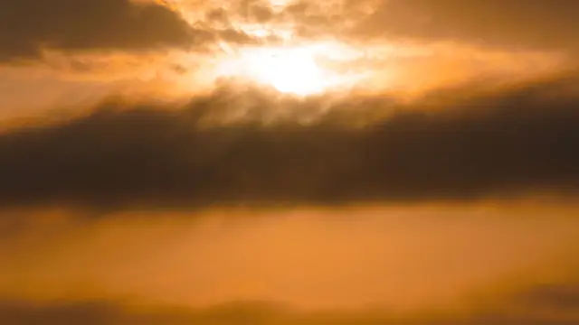 Golden sun setting over ocean horizon