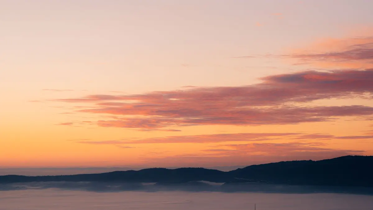 Sunrise over a misty mountain range